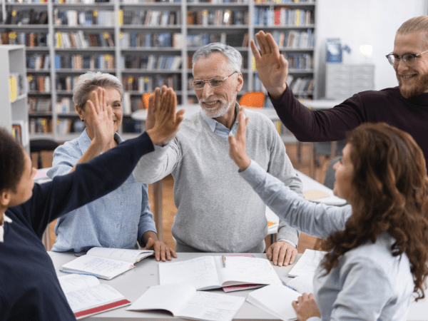 people-high-five-library-close-up people-high-five-library-close-up